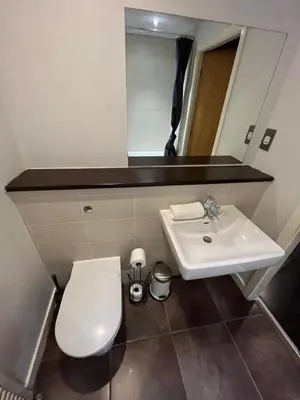 a bathroom with a white toilet and a sink at City centre stylish apartment in Glasgow