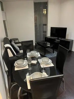 a dining room with a table with chairs and a piano at City centre stylish apartment in Glasgow