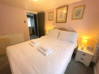 a bedroom with a white bed with two towels on it at Cosy Cottage in Moffat Town Centre - Pass the Keys in Moffat