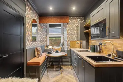 a small kitchen with a table and a sink at Boutique Studio Near Stirling in Cambusbarron