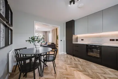 a kitchen with a table and chairs in a kitchen at JW Canmore ApartHouse in Glasgow