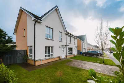 a house with a car parked in the driveway at JW Canmore ApartHouse in Glasgow