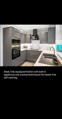 a kitchen with stainless steel appliances and a streamlined layout forasteradobeadobeadobeadobe at 2BR bed home peaceful central area free parking in Oban
