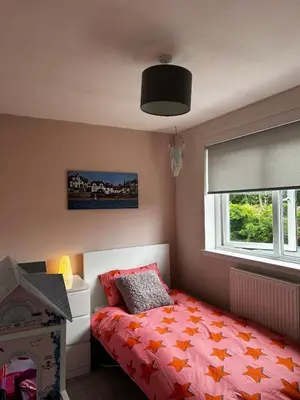 a bedroom with a bed and a window at The Beach View - Greenan in Ayr