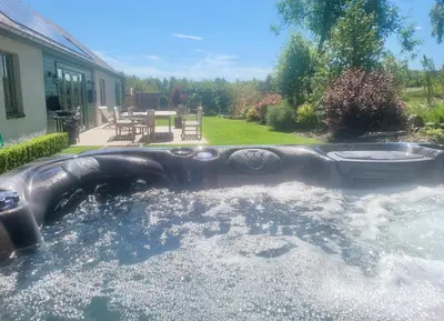 a large pool of water in a backyard at The Steading In The Park in Stirling