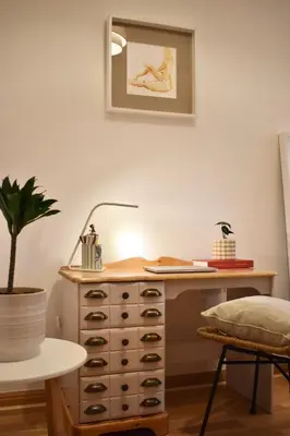 a desk with a lamp and a plant in a room at Luxury Historic City-Centre Flat & Free Parking in Glasgow