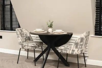 a black table with two chairs and a black table and chairs at South Lane Apartments - City Centre in Edinburgh