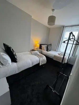 a room with two beds and a ladder in it at Anchor stays - your steady base away from home in Cambusnethan