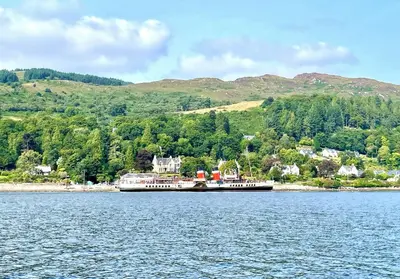 a large boat on a large body of water at Pier Cottage at Kames in Kames