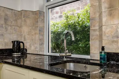 a kitchen with a sink and a window at Stirling Edwardian House - Fireplace,Garden,Parking in Stirling