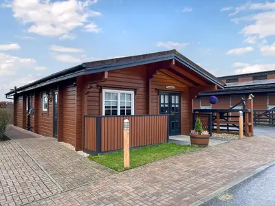 a small wooden house with a brick driveway at Conemara - Uk51249 in Glasgow