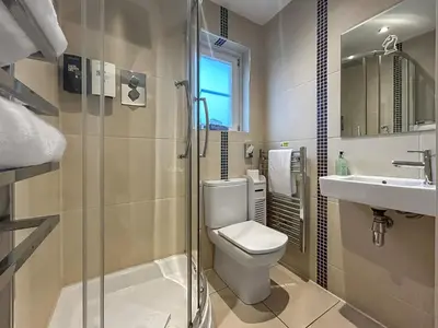 a bathroom with a toilet and a sink and a shower at Conemara - Uk51249 in Glasgow