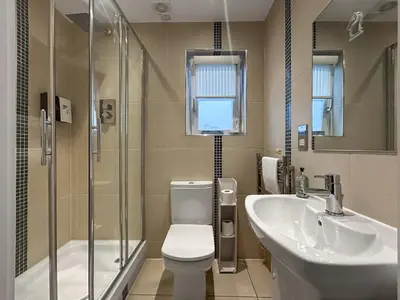 a bathroom with a toilet and a sink and a shower at Conemara - Uk51249 in Glasgow