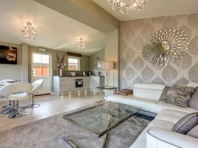 a living room with a white couch and a table at Conemara - Uk51249 in Glasgow