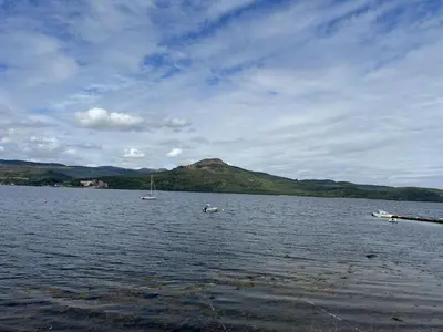 a large body of water with two boats in it at Mid- Village Croft in Cairndow