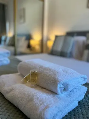 a pile of towels sitting on top of a bed at Central 1BR Apt with Parking in Auchterarder