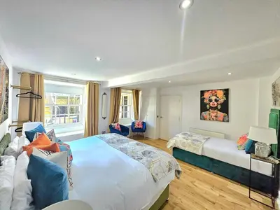 a bedroom with a large bed and a couch at Stellar Apartments - 2 & 3 Bedroom Apartments in Edinburgh