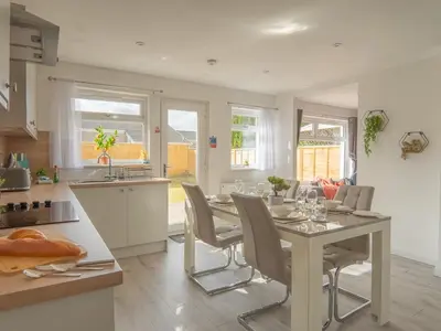 a kitchen and dining room with a table and chairs at Etive House - 3 bedroom stylish home in Cumbernauld