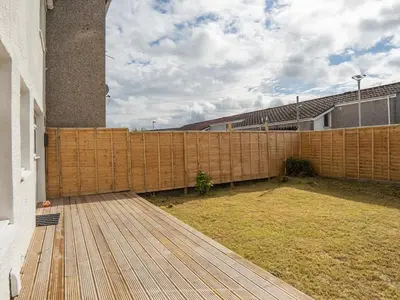 a wooden fence in a yard next to a building at Etive House - 3 bedroom stylish home in Cumbernauld