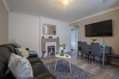 a living room with a couch and a table at Culzean House - 2 Bedrooms in Coatbridge in Coatbridge