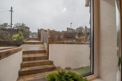 a view from the balcony of a building with wooden stairs at Lynwood - 4 Bedroom House with Views of Loch Gilp in Ardrishaig