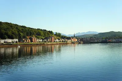 a large body of water with houses and buildings at Harbour View - Luxury Town Centre Property in Rothesay