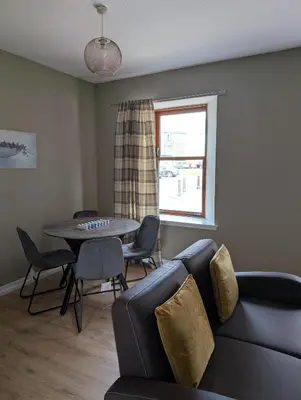 a living room with a couch and a table and a window at Argyll Place in Campbeltown