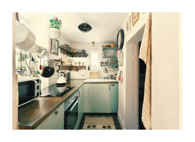 a kitchen with blue cabinets and a counter top at Historic Hideaway - Dean Village in Edinburgh