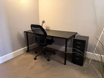a black desk with a chair and a speaker at Spacious Three Storey West End Home - 3 bedroom in Glasgow