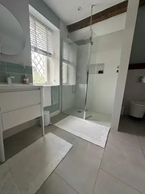 a bathroom with a shower and a sink and a toilet at Charming Cotswold stone cottage with garden in Moffat