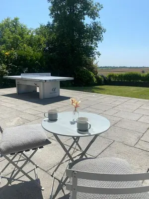 a table and two chairs and a bench on a patio at Tranquil Countryside Escape in Moffat