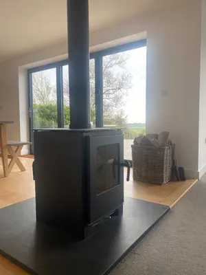 a fireplace in a room with a living room at Tranquil Countryside Escape in Moffat