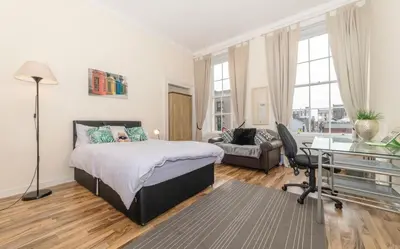 a bedroom with a bed and a desk at 7 Bedroom Apartment - City Centre in Glasgow