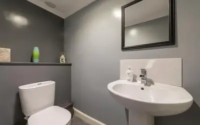 a bathroom with a white toilet and a sink at 7 Bedroom Apartment - City Centre in Glasgow