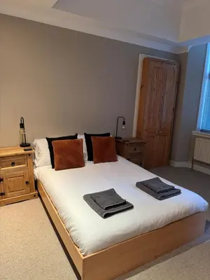 a bedroom with a bed with two towels on it at Auldhouse Apartment entire place 2 bedrooms in Mansewood