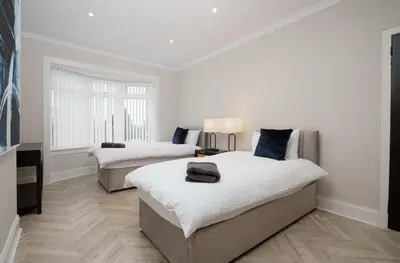 a white room with two beds and a couch at 3BR Home Sleeps 6 Near Airport with Parking