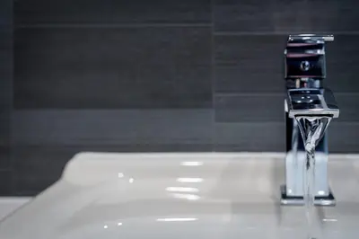a close up of a bathroom faucet on a sink at 3BR Home Sleeps 6 Near Airport with Parking