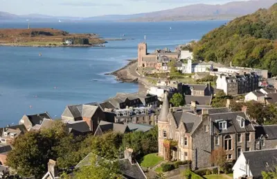 a town with houses and a body of water at Cruachan View Caravan Farm stay in Oban