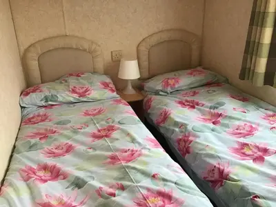 two beds sitting next to each other in a room at Cruachan View Caravan Farm stay in Oban