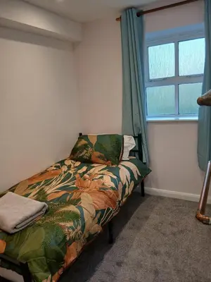a bedroom with a bed and a window at Fabulous 4 Bed House in Leiston in Moffat