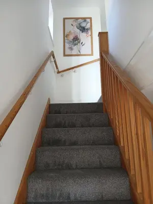 a stairway with a picture on the wall at Fabulous 4 Bed House in Leiston in Moffat