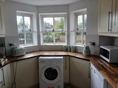 a kitchen with a washing machine on a counter at Fabulous 4 Bed House in Leiston in Moffat