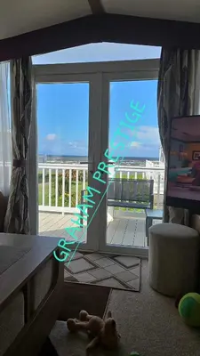 a room with a sliding glass door with a view of a balcony at Grahams Prestige Craig Tara in Minishant