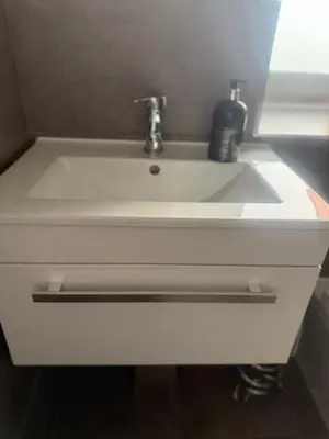 a white bathroom sink with a soap dispenser on it at Murrayfield Executive Apartment in Edinburgh