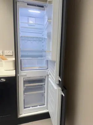 an empty refrigerator with its door open in a kitchen at Murrayfield Executive Apartment in Edinburgh