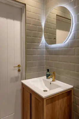 a bathroom with a sink and a mirror at Cosy Callander One Bed Apartment Wood Burner and Free Parking in Callander