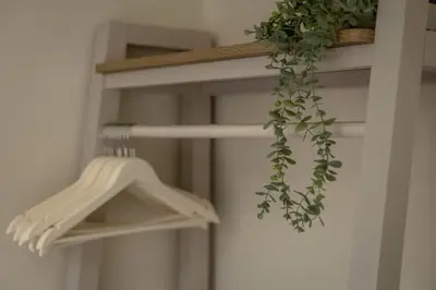 a plant is hanging from a white closet at Cosy Callander One Bed Apartment Wood Burner and Free Parking in Callander
