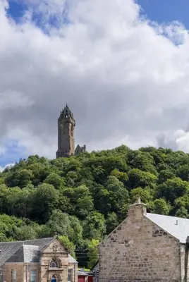 a castle on top of a hill with trees at The Bruces Quarter in Stirling