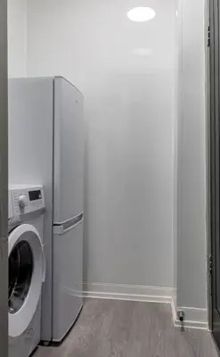 a washer and dryer in a white room at Caledonia Suite by The Wallace Monument in Stirling