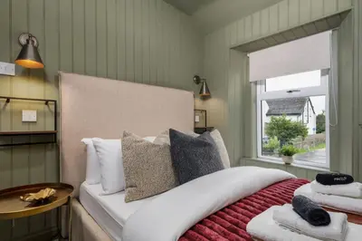 a bedroom with a large bed and a window at The Braveheart Suite by The Wallace Monument in Stirling